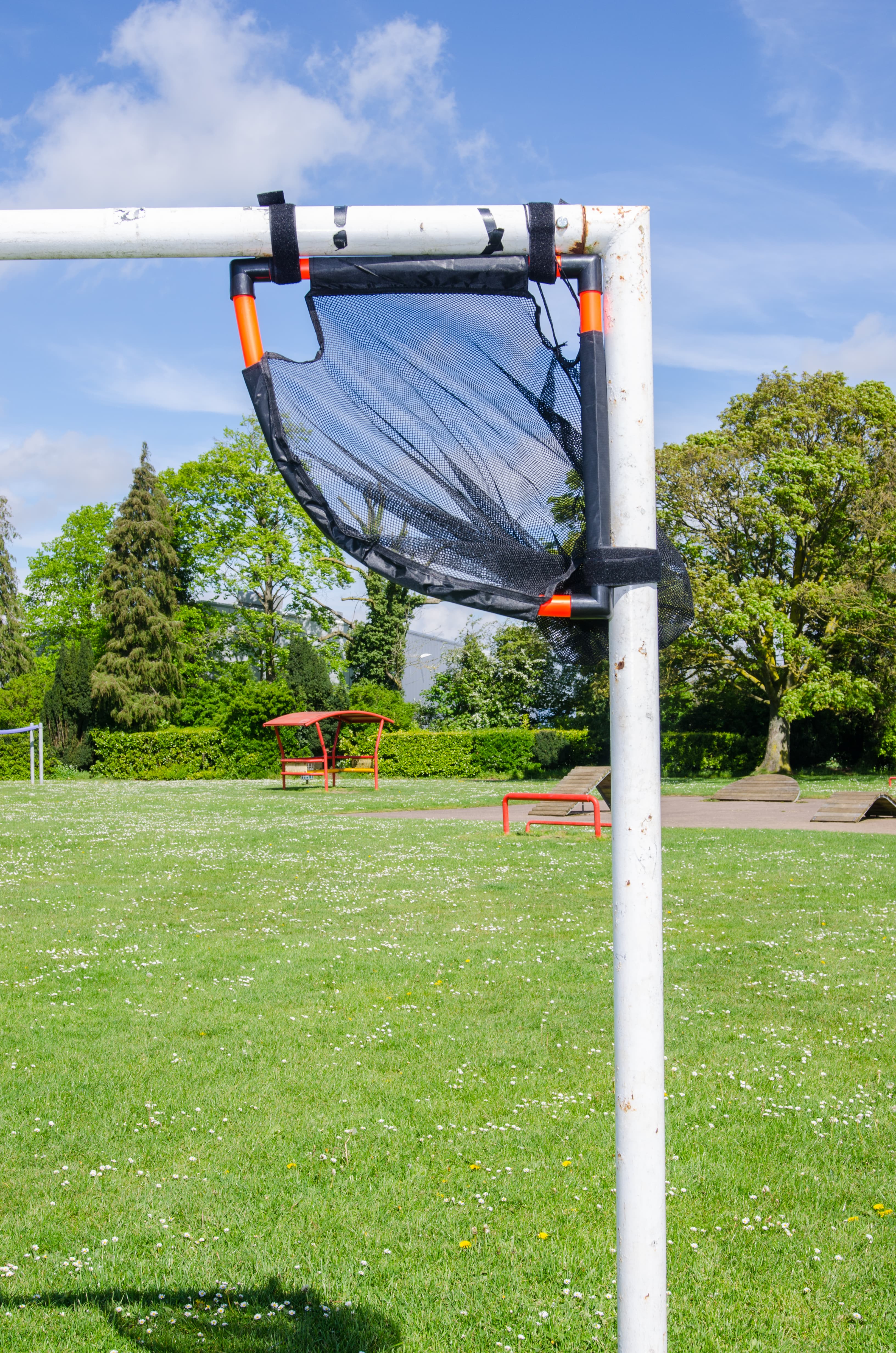 Portrait photo of the TopCorner target fitted to the goal post in a full outdoor view